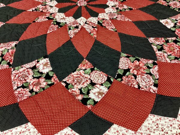 Close-up of the large dahlia in red, black and rose print fabric